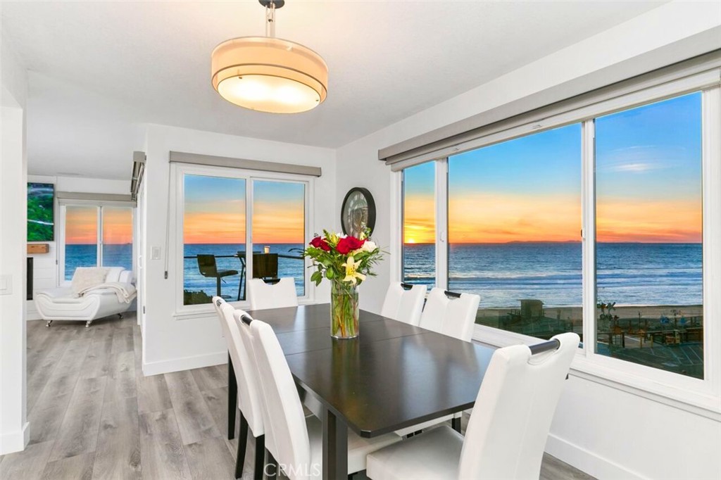 121 Boca De La Playa, Unit 1 San Clemente, CA 92672 - Photo 9 of 47 a dining room with furniture wooden floor and a chandelier