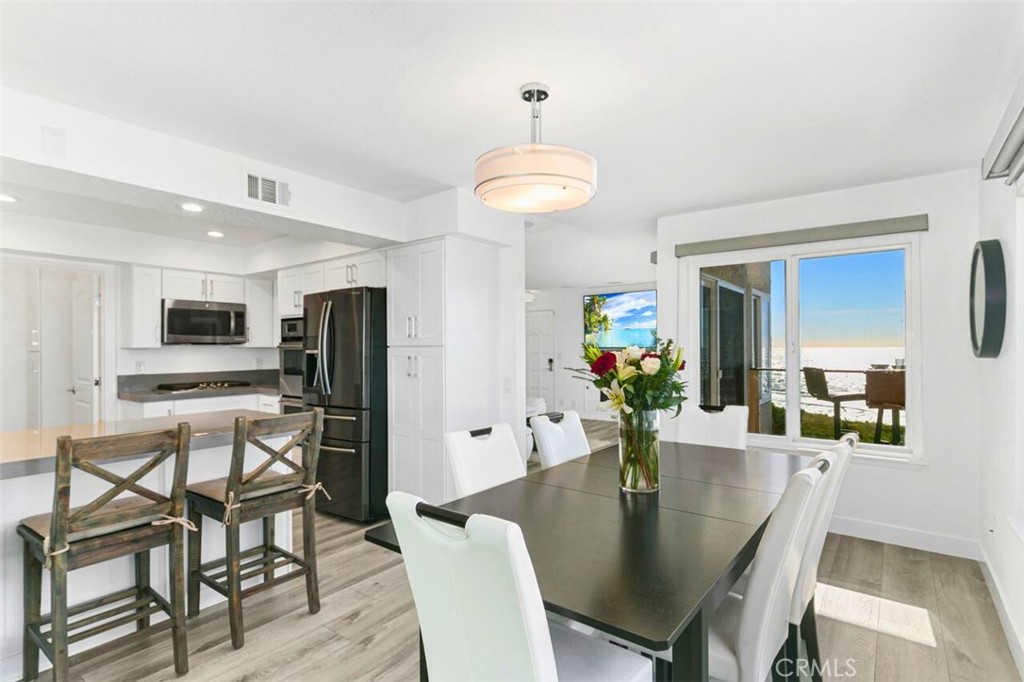 121 Boca De La Playa, Unit 1 San Clemente, CA 92672 - Photo 10 of 47 a view of a dining room with furniture and wooden floor