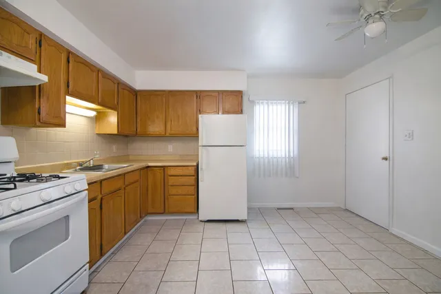 a kitchen with a stove a sink and a refrigerator