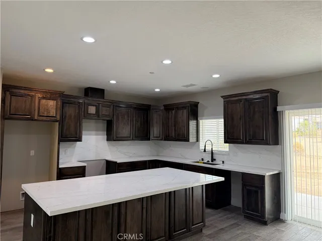 a kitchen with a sink cabinets and window