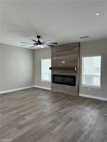 a view of an empty room with a window and a fireplace