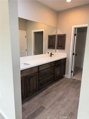 a bathroom with a double vanity sink and mirror