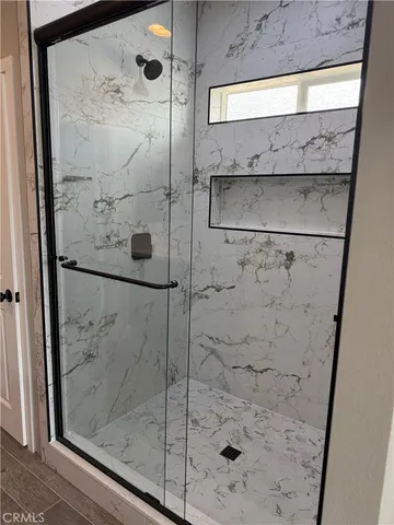 a bathroom with a glass shower door