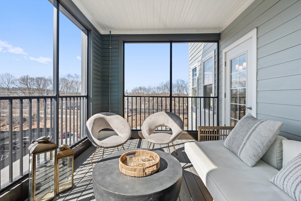 60 Coppersmith Way, Unit 407 Canton, MA 02021 - Photo 22 of 34 a table and chairs in a living room