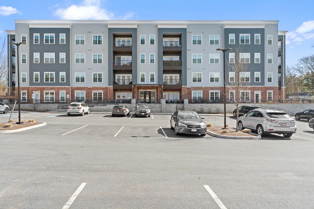 60 Coppersmith Way, Unit 407 Canton, MA 02021 - Photo 27 of 34 a view of a cars parked in front of a building