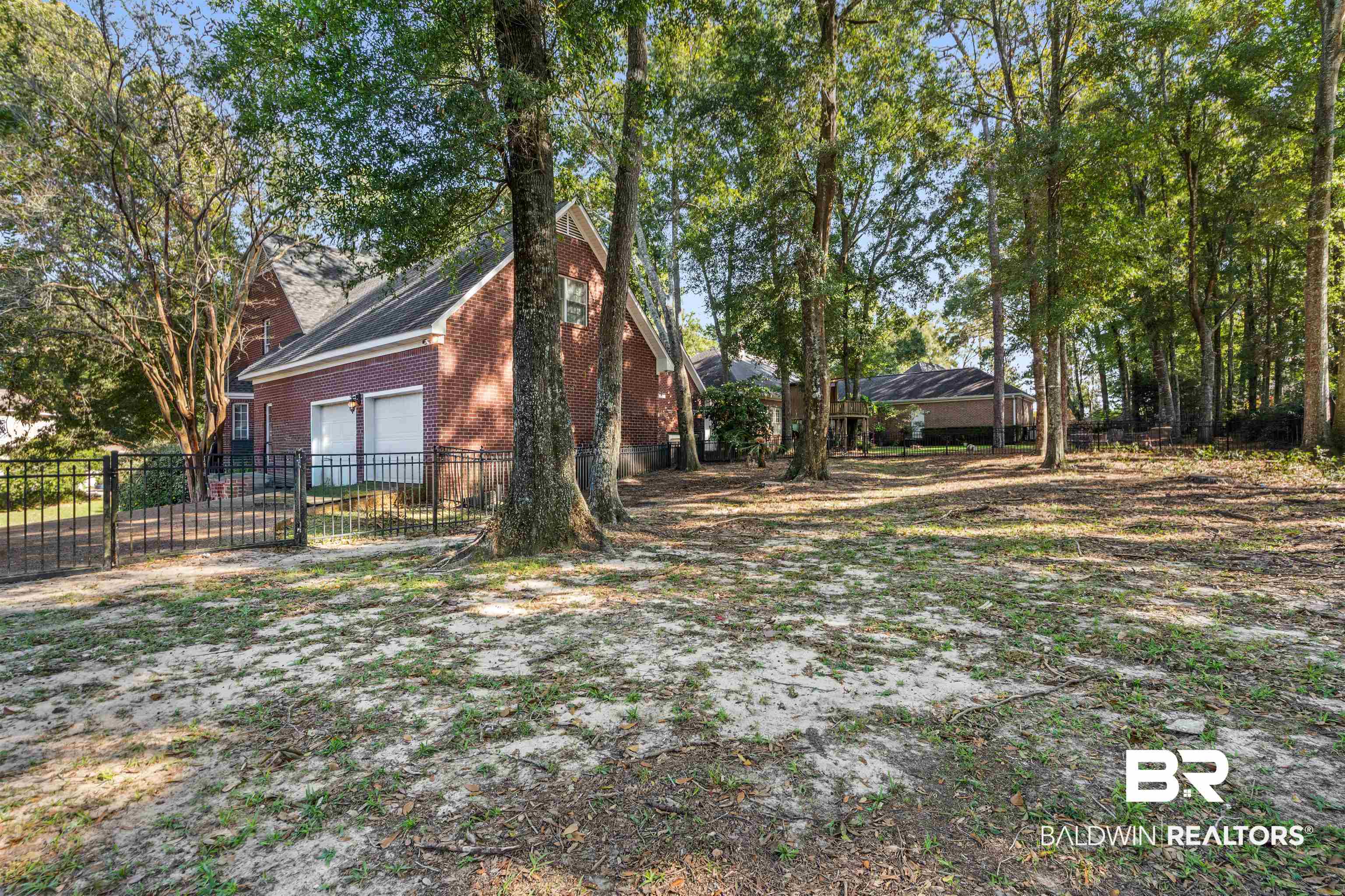 107 Beaver Dam Road Fairhope, AL 36532 - Photo 31 of 45 View of home's exterior featuring a garage and brick siding