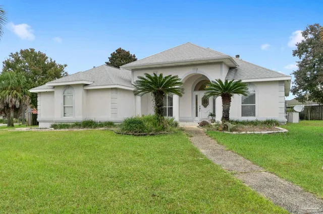 a front view of house with yard and outdoor seating