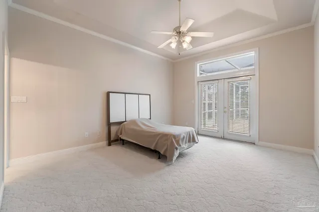 a spacious bedroom with a bed and a chandelier