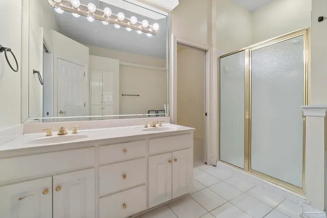 a bathroom with a double vanity sink mirror and