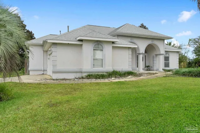 a front view of a house with a garden