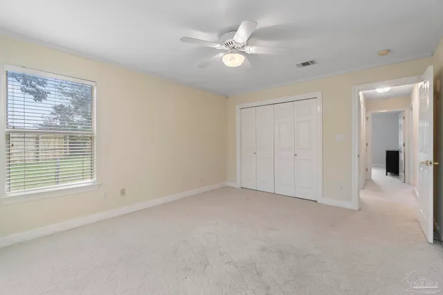 an empty room with windows and closet