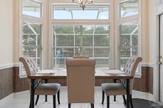 a kitchen with white cabinets and refrigerator