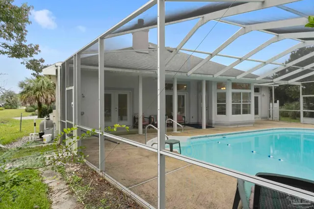 a view of a house with a backyard