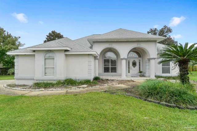 a front view of a house with garden