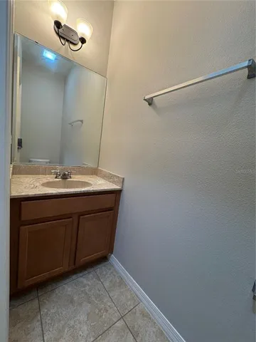 a bathroom with a sink vanity and mirror