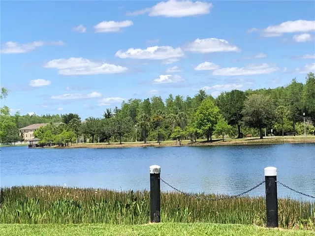 a view of a lake with a house in the background