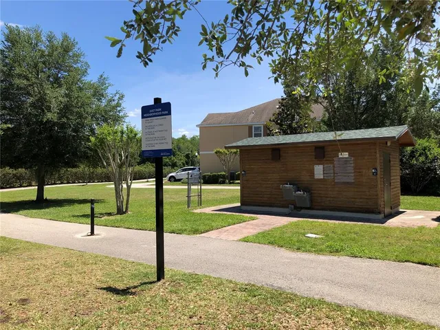 a front view of a house with a yard and tree