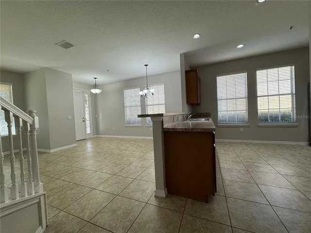 a view of a kitchen with a sink and cabinets