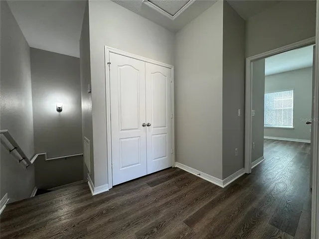 an empty room with wooden floor and closet