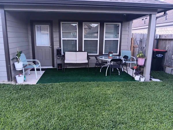 a view of a house with backyard porch and sitting area
