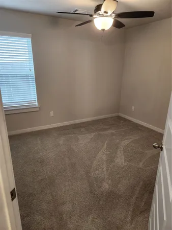 en empty room with window and fan