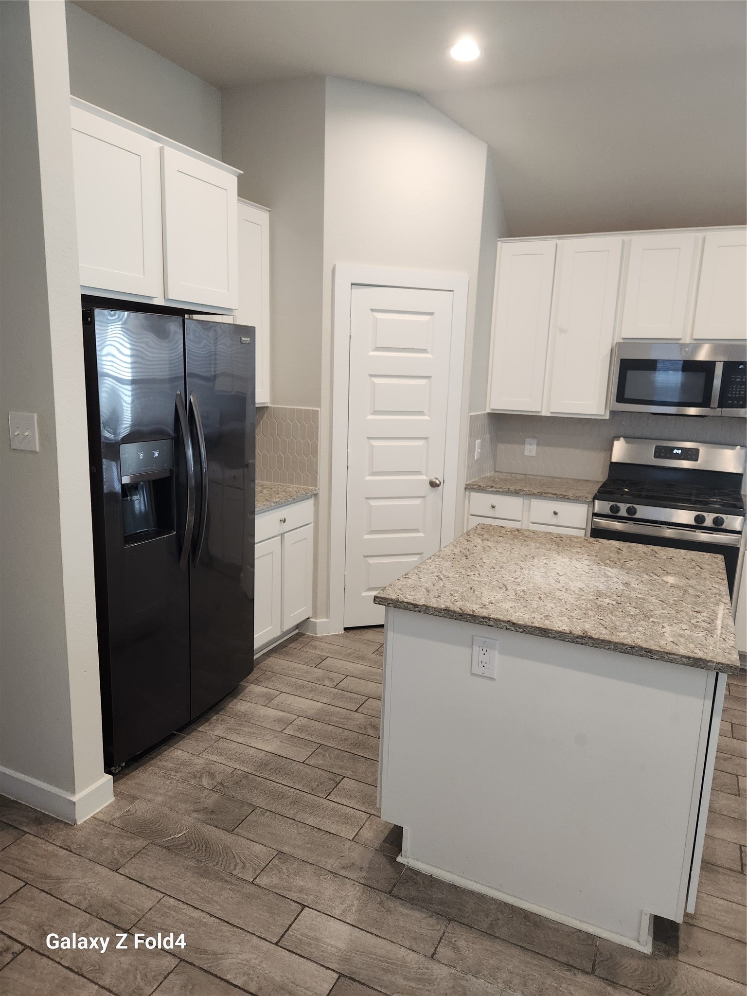 4326 Wyanngate Drive Spring, TX 77373 - Photo 6 of 29 a kitchen with granite countertop a refrigerator and a stove
