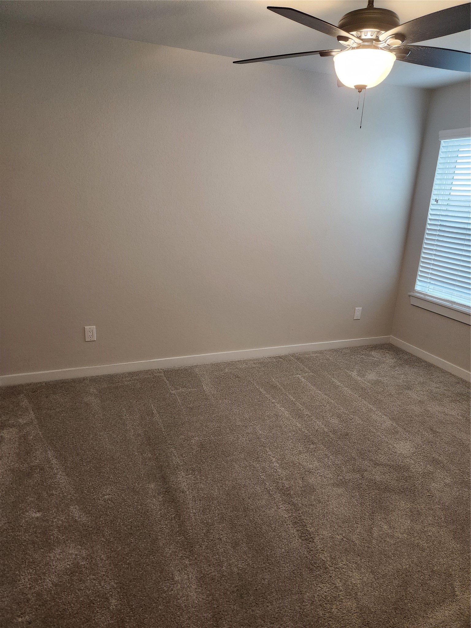 4326 Wyanngate Drive Spring, TX 77373 - Photo 8 of 29 an empty room with a window and a fan