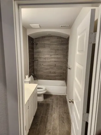 a bathroom with a bathtub and toilet