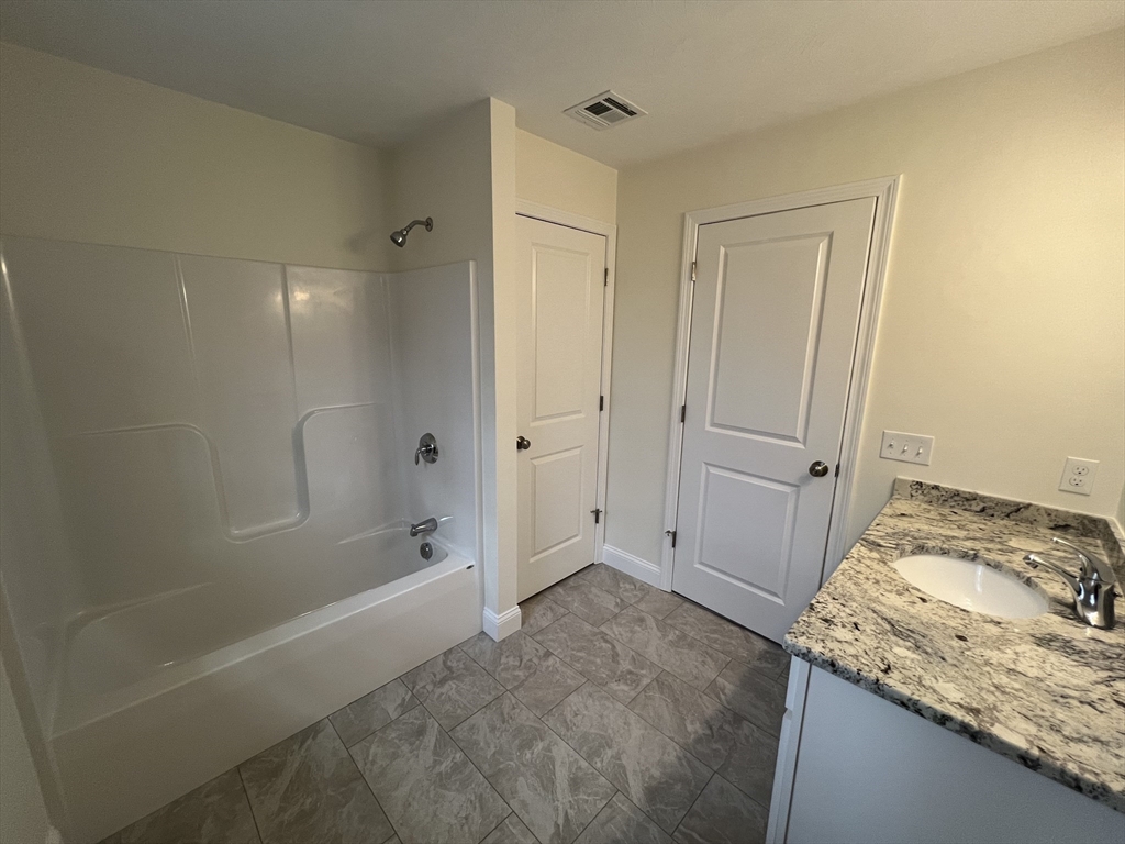 40 A Titus Way, Unit 40A Taunton, MA 02780 - Photo 11 of 16 a bathroom with a granite countertop sink and shower