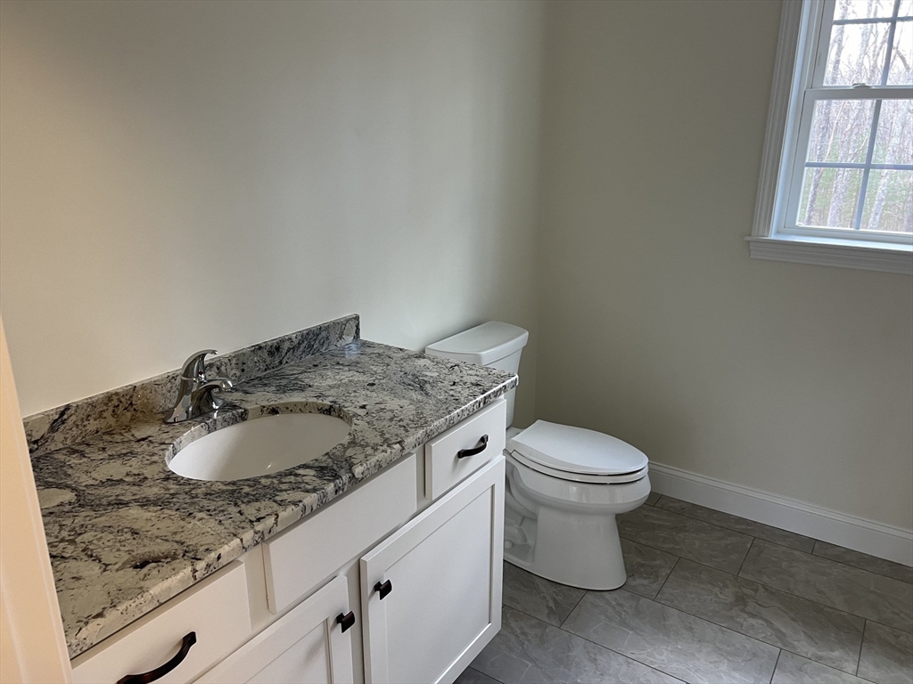 40 A Titus Way, Unit 40A Taunton, MA 02780 - Photo 12 of 16 a bathroom with a granite countertop sink and a toilet