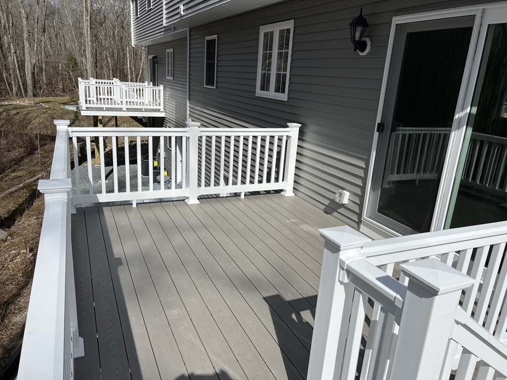 40 A Titus Way, Unit 40A Taunton, MA 02780 - Photo 16 of 16 a view of deck with two chairs and wooden floor