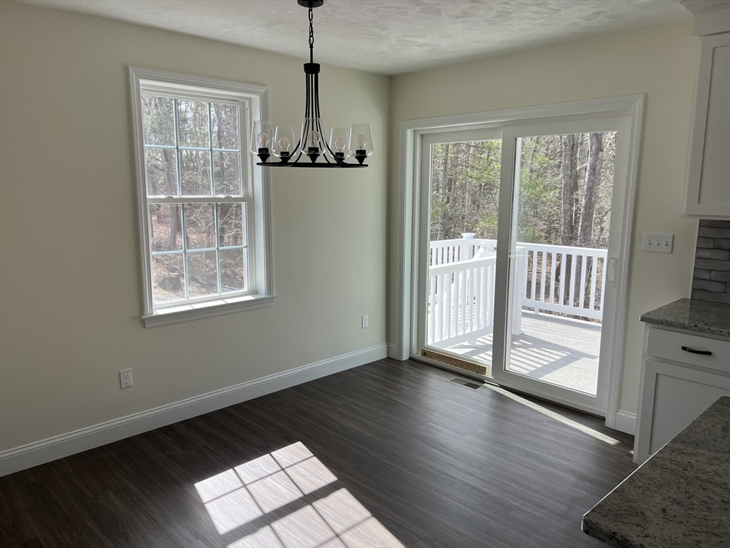 40 A Titus Way, Unit 40A Taunton, MA 02780 - Photo 5 of 16 a view of an empty room with wooden floor and a window