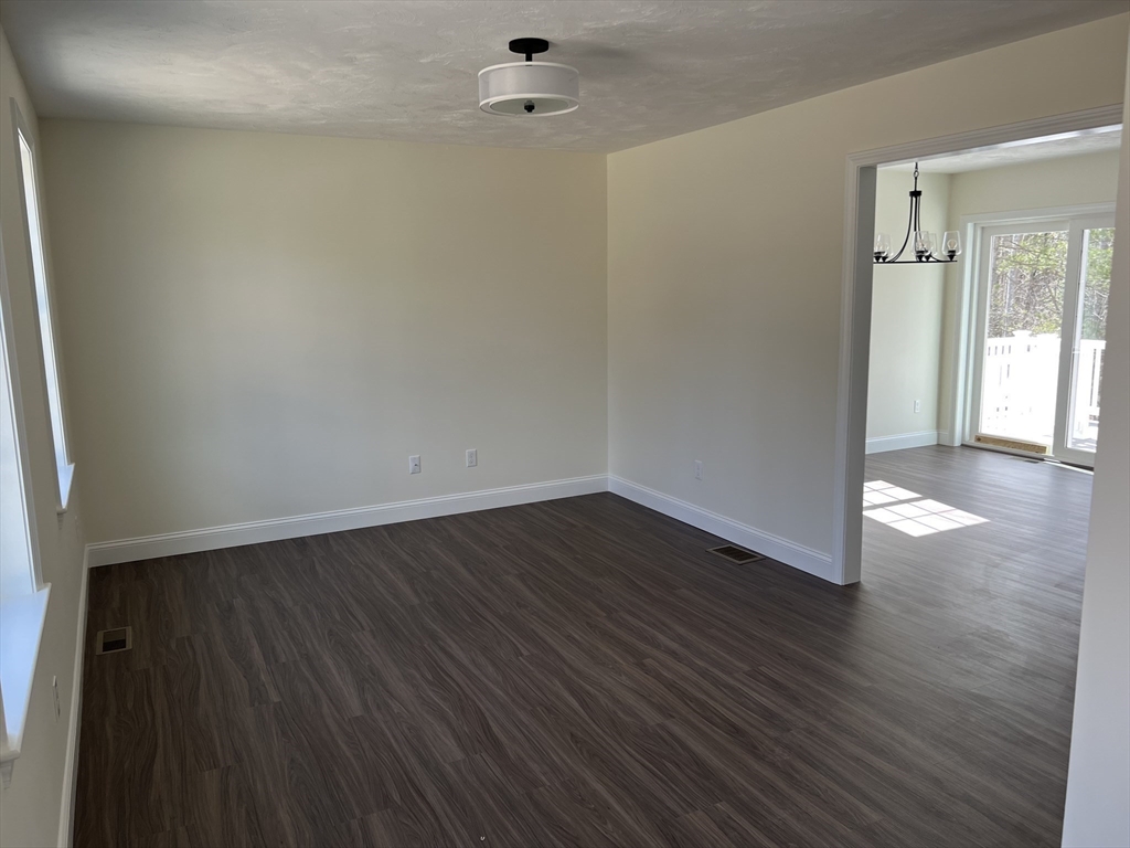 40 A Titus Way, Unit 40A Taunton, MA 02780 - Photo 6 of 16 wooden floor in an empty room with a window