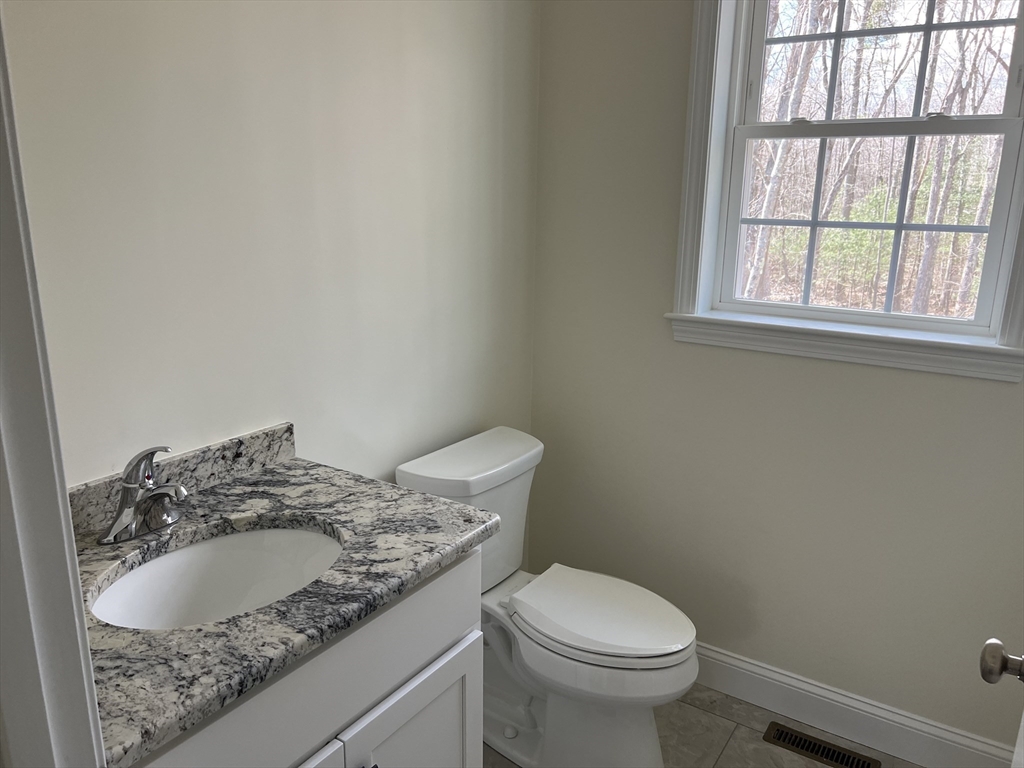 40 A Titus Way, Unit 40A Taunton, MA 02780 - Photo 7 of 16 a bathroom with a granite countertop toilet and a sink