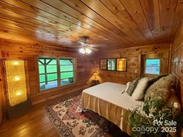 a bed sitting in a bedroom next to a window