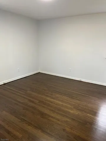 a view of an empty room and wooden floor