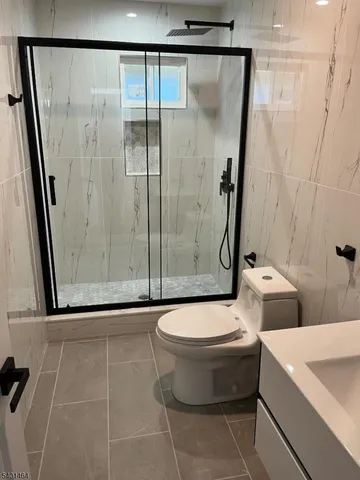 a bathroom with a toilet and a shower