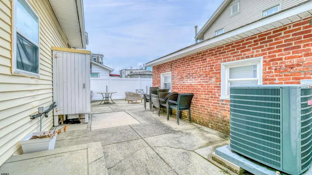 a backyard of a house with outdoor seating