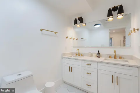 a bathroom with a toilet sink and mirror