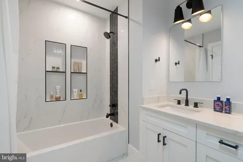 a bathroom with a double vanity sink toilet and mirror