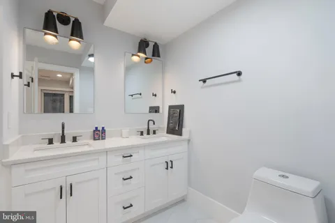 a room with white cabinets and window