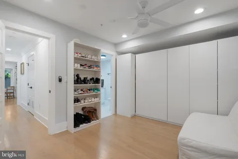 a living room with furniture and a ceiling fan