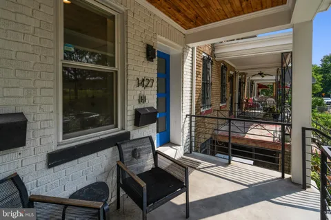 a view of a house with a porch and furniture