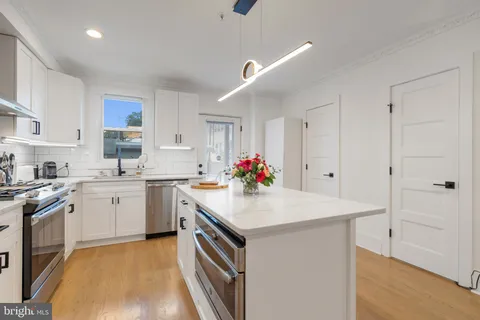 a kitchen with a sink stove and cabinets