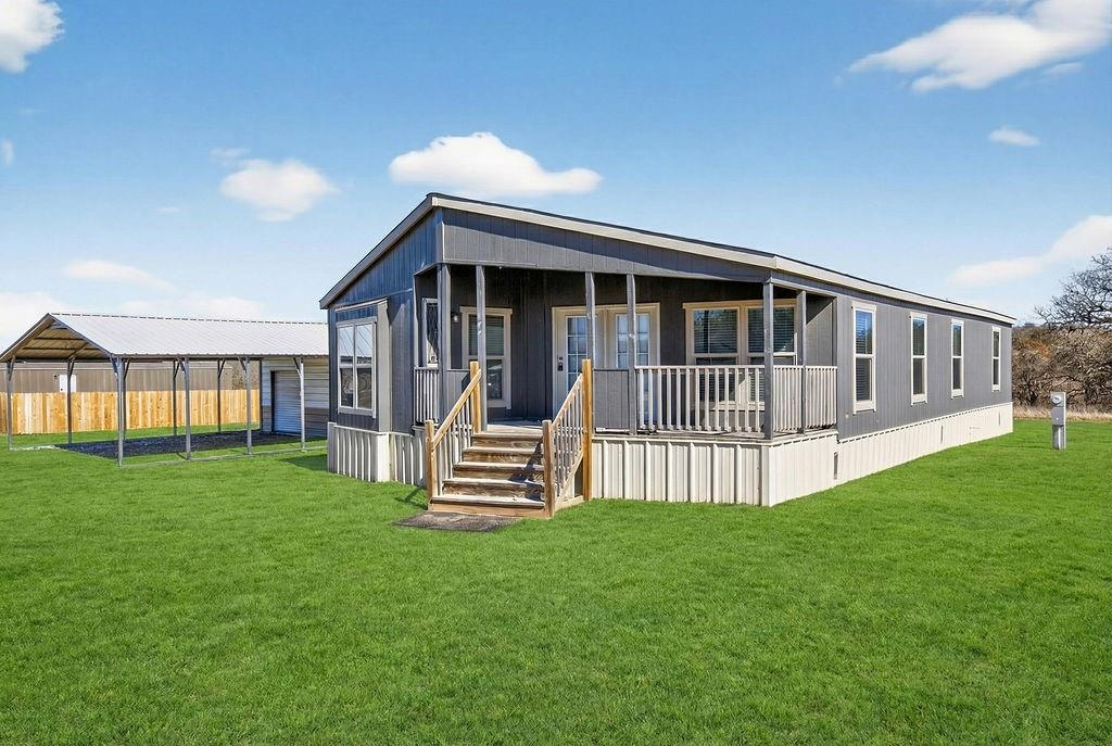 154 Firefly Drive Springtown, TX 76082 - Photo 1 of 39 a view of a house with a yard and deck