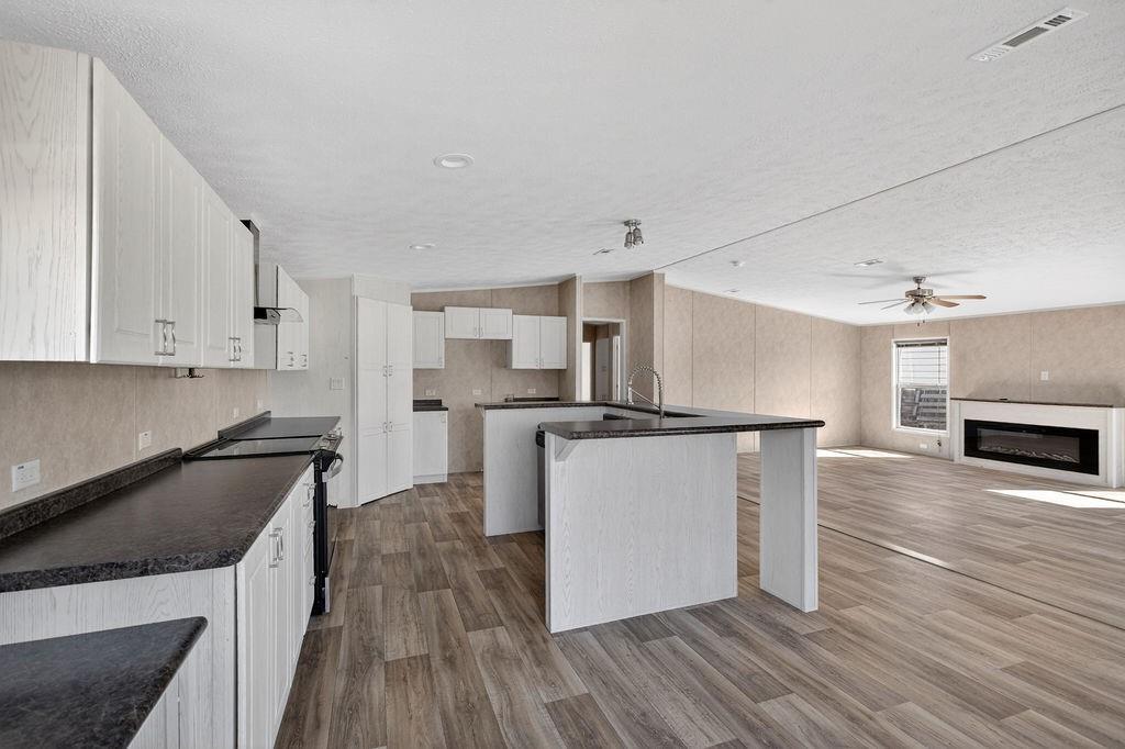154 Firefly Drive Springtown, TX 76082 - Photo 11 of 39 a kitchen with cabinets and stainless steel appliances