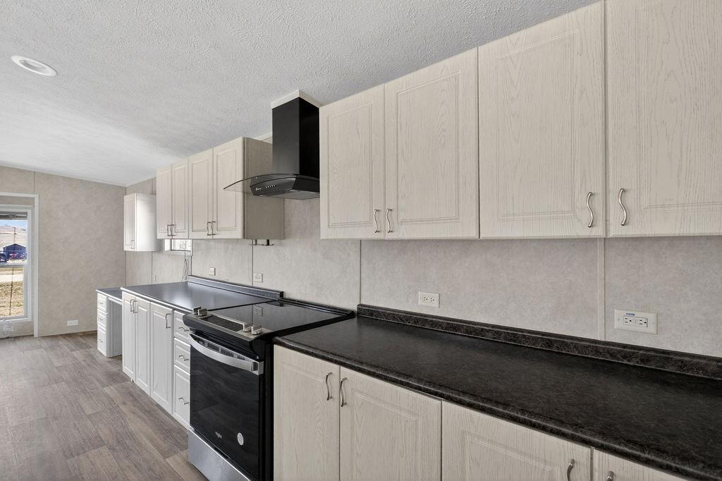 154 Firefly Drive Springtown, TX 76082 - Photo 13 of 39 a kitchen with granite countertop white cabinets and black appliances