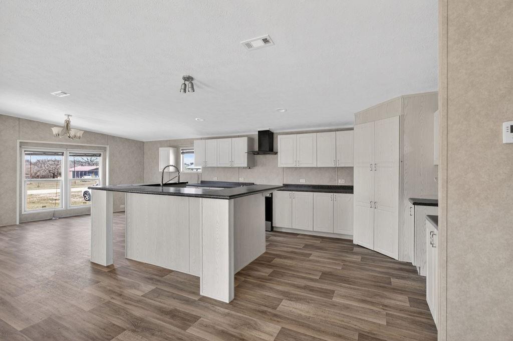 154 Firefly Drive Springtown, TX 76082 - Photo 14 of 39 a kitchen with granite countertop white cabinets and white appliances