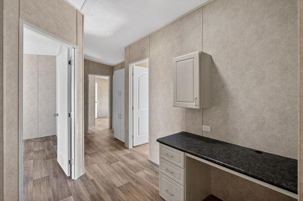 154 Firefly Drive Springtown, TX 76082 - Photo 16 of 39 a kitchen with granite countertop a stove and a refrigerator