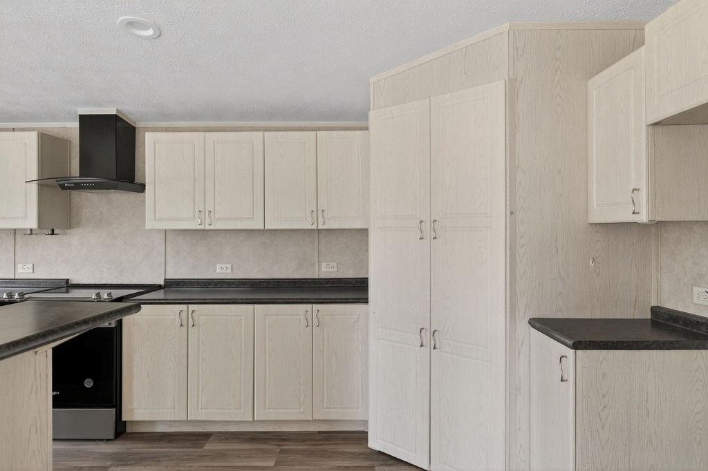 154 Firefly Drive Springtown, TX 76082 - Photo 18 of 39 a kitchen with stainless steel appliances granite countertop white cabinets and a refrigerator